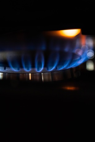 Blue flames coming out of a stove.
