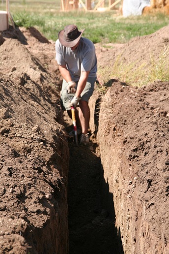 a person digging the pipes underground