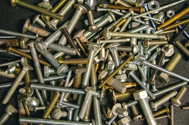 Several screws and nuts on a surface