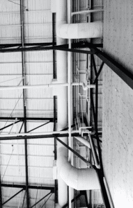 Convoluted plumbing outside a commercial building