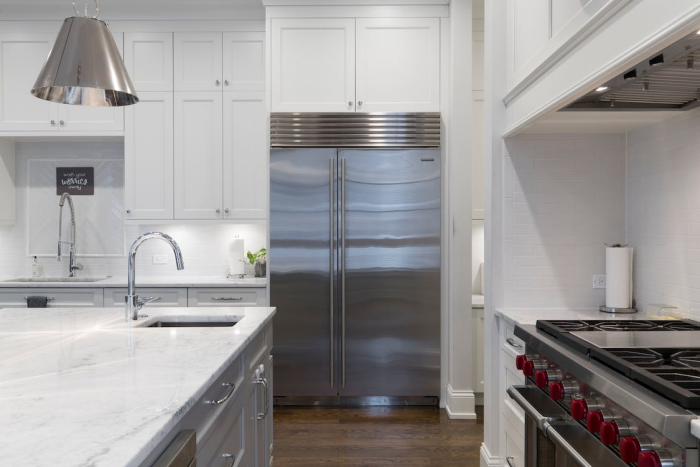 sink in the kitchen island with stainless steel appliances
