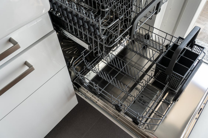 an empty open dishwasher