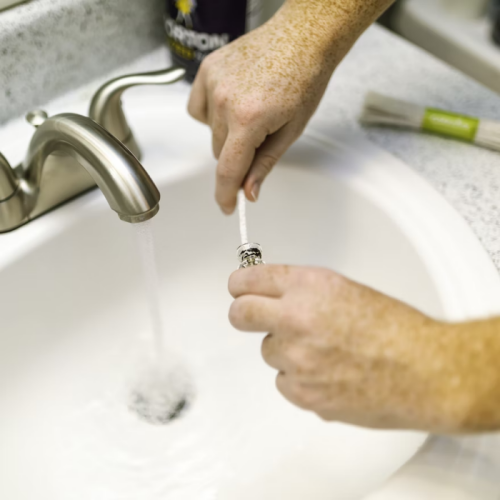 a person cleaning something in a sink